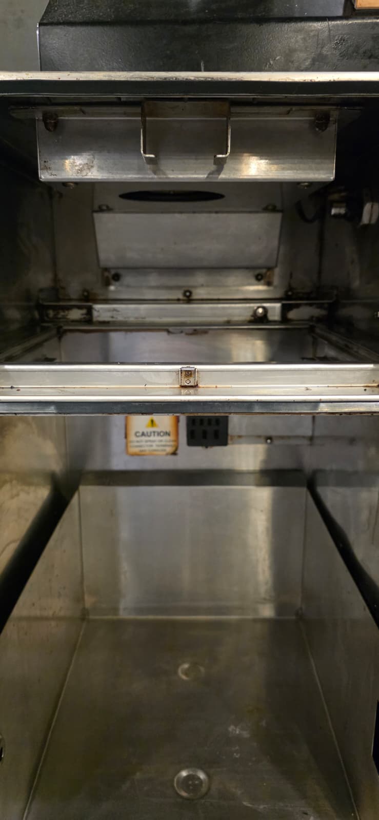 Perfect Fry interior after deep cleaning, showing the upper metal housing with its handle and opening above the lower compartment.
