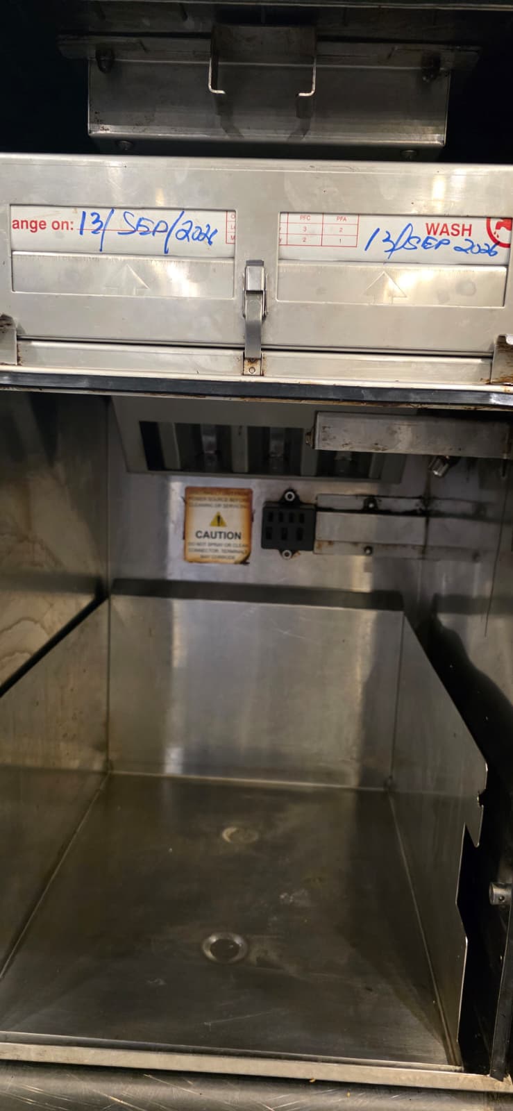 Perfect Fry interior after deep cleaning, with the filter panel and handwritten maintenance labels above the open lower compartment.