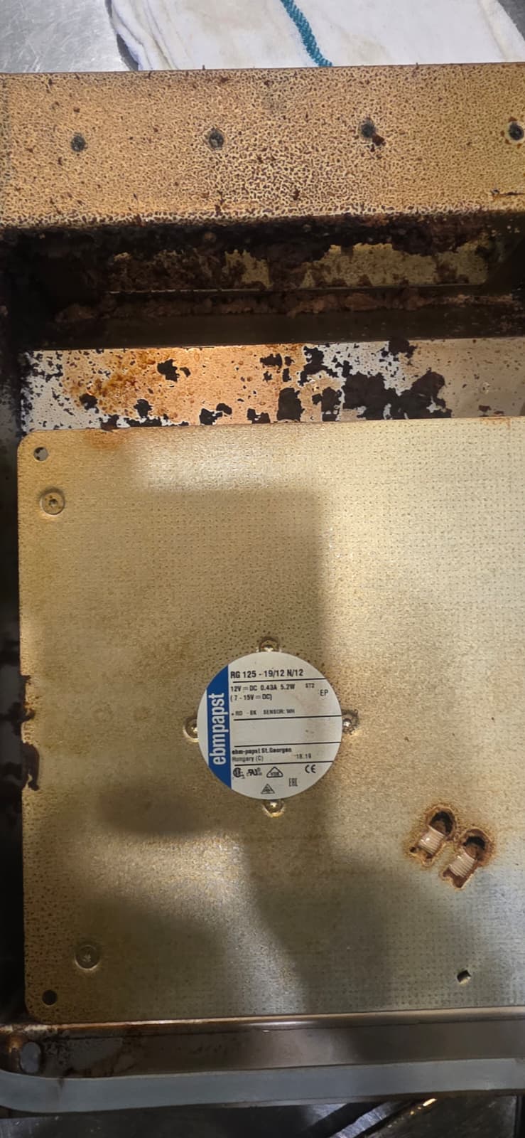 Removed Perfect Fry fan panel with dark residue around the edges before deep cleaning.